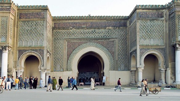 The Bab Mansour gate, an ornate entrance to the city of Meknes with intricate tilework and arches.