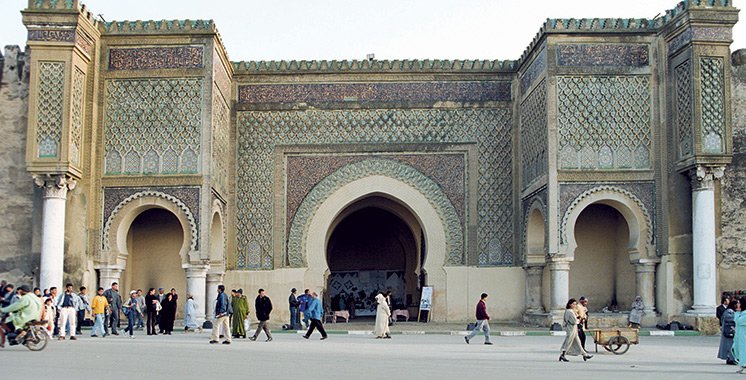 The Bab Mansour gate, an ornate entrance to the city of Meknes with intricate tilework and arches.