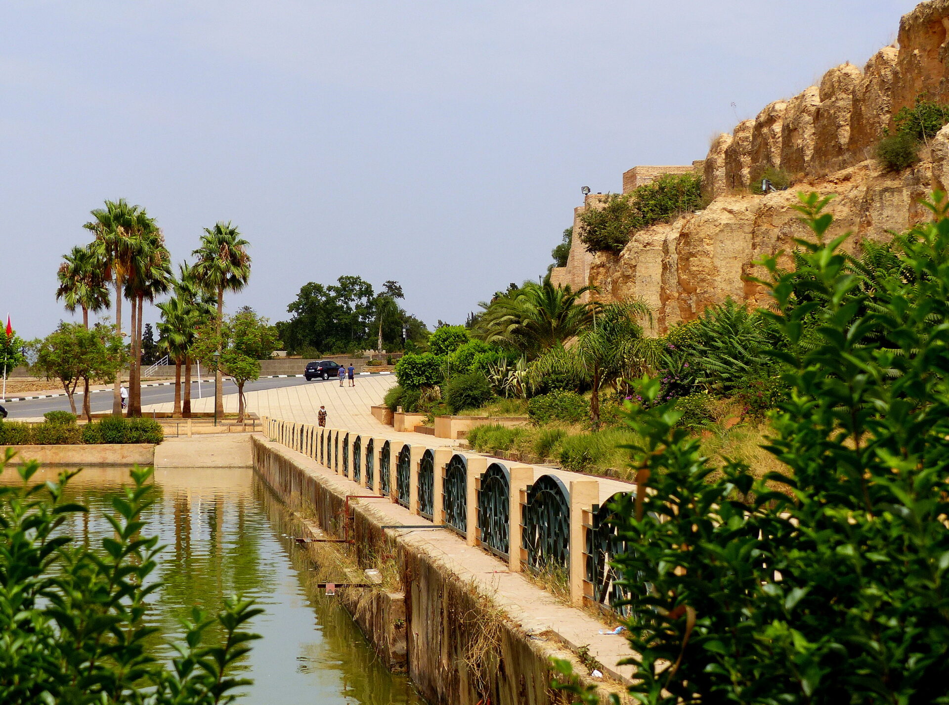 Heri es Souani Gardens or Sahrij Swani Gardens in Meknes with fountains, palm trees, and pathways.