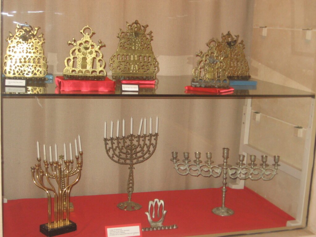 A display of colorful menorahs at the Jewish Museum in Casablanca, Morocco, showcasing the traditions of Moroccan Jews during their celebrations and festivals.