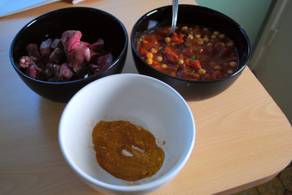 Image of the ingredients used in Moroccan Harira Soup, including lentils, chickpeas, tomatoes, and spices. This image highlights the nutritious components of the dish.