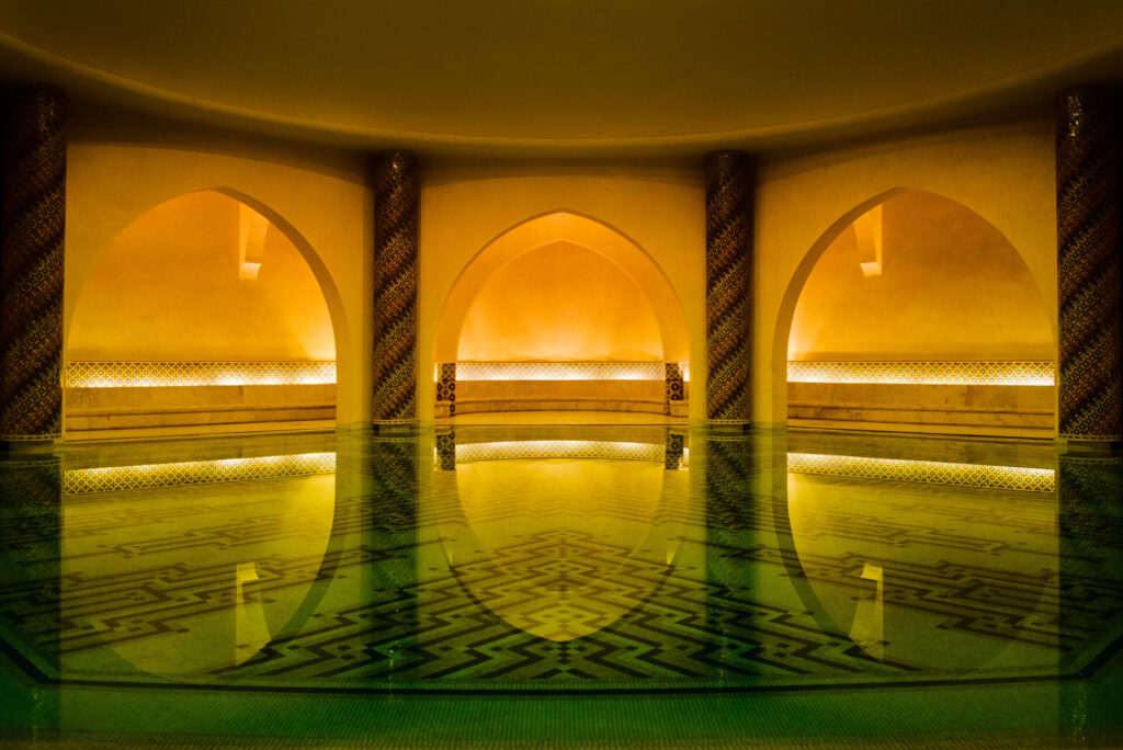 The Turkish bath at Hassan II Mosque, a beautifully tiled space with a roaring fireplace, awaiting its grand opening for visitors.