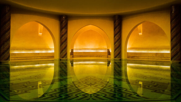 The Turkish bath at Hassan II Mosque, a beautifully tiled space with a roaring fireplace, awaiting its grand opening for visitors.