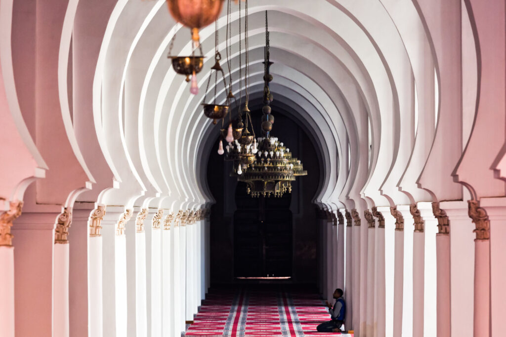 Majestic interior view of the entrance to the Koutoubia Mosque in Marrakech, Morocco, showcasing its spiritual significance.