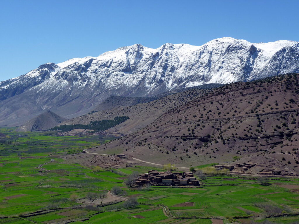 A captivating view of Tabant village in the Aït Bouguemez Valley, surrounded by majestic mountains. The image showcases the scenic beauty and tranquility of the valley, offering a perfect setting for outdoor adventures such as hiking and nature exploration. 