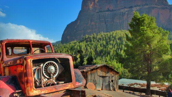 Landscape view of the Cathedral Mountain in Azilal, region of Beni Mellal, with an abandoned truck in the foreground.