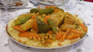 Image of a lavish banquet in Rabat, Morocco, featuring the Moroccan national dish - couscous. A tantalizing culinary journey through rich flavors and cultural heritage.