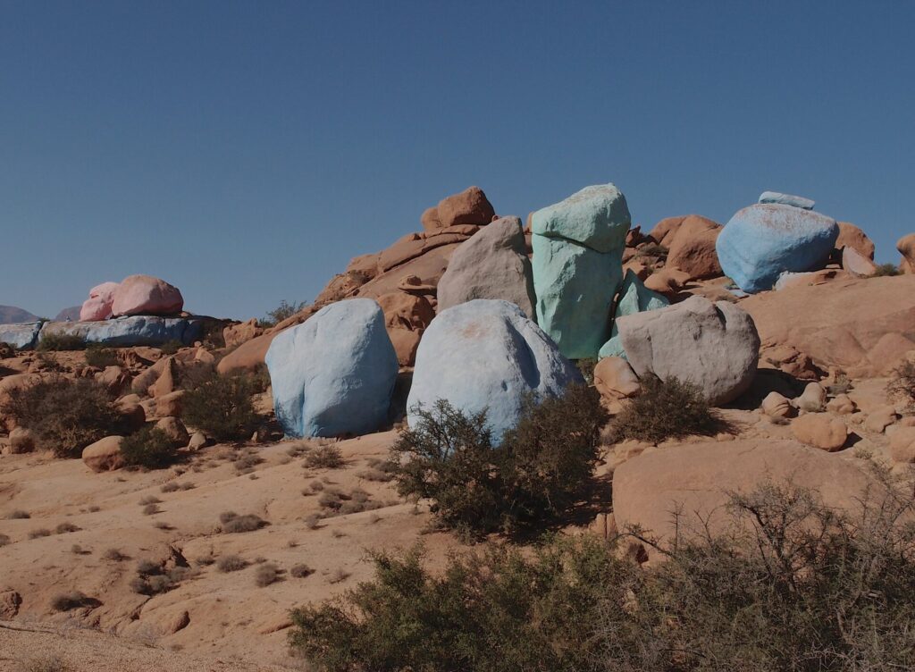 Vibrant colored rocks in Tafraout, Morocco, showcasing stunning geological formations amidst a scenic landscape